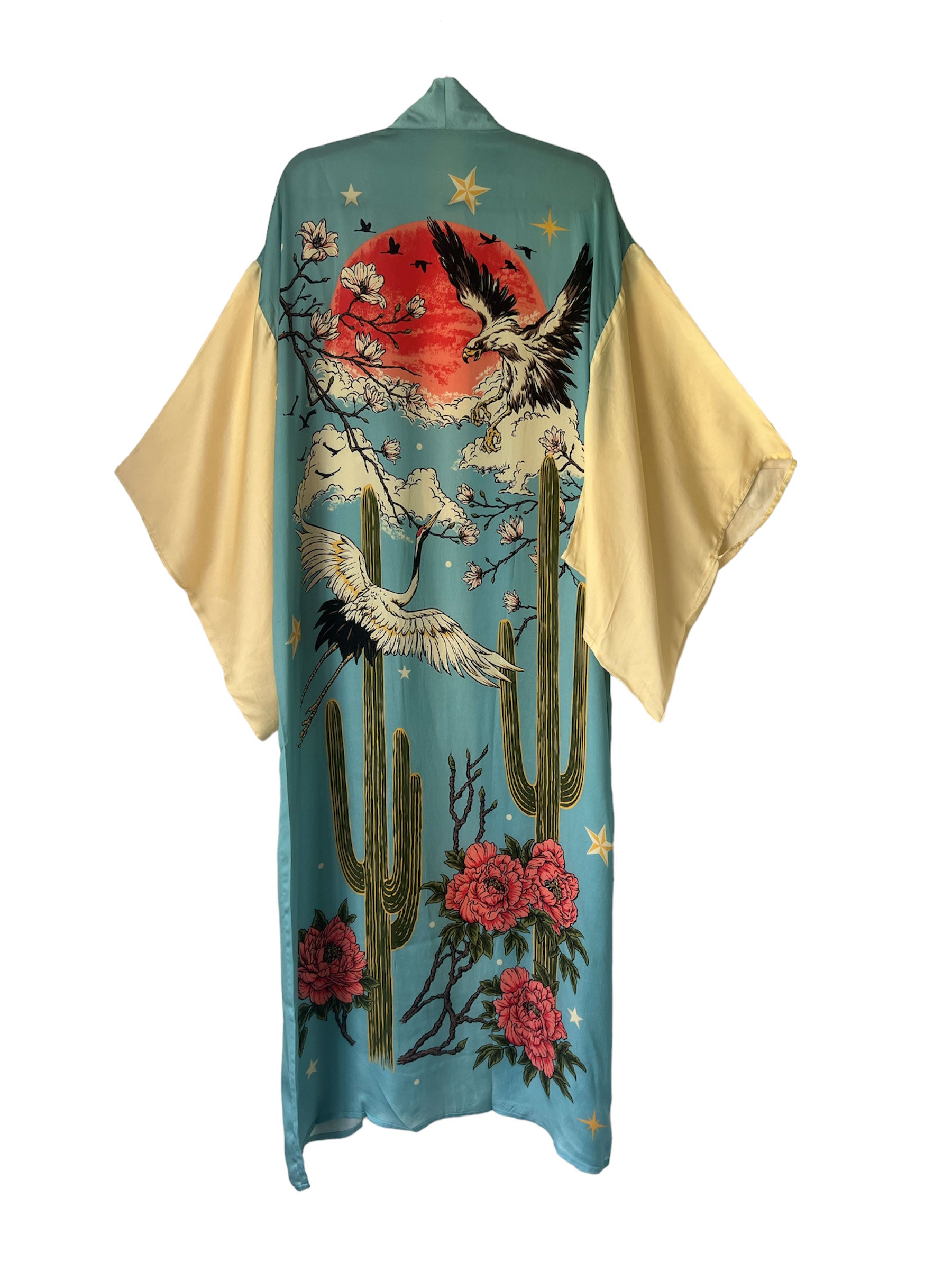 A sky blue kimono with intricate crane, moon, eagle, and cactus designs in gold and red.