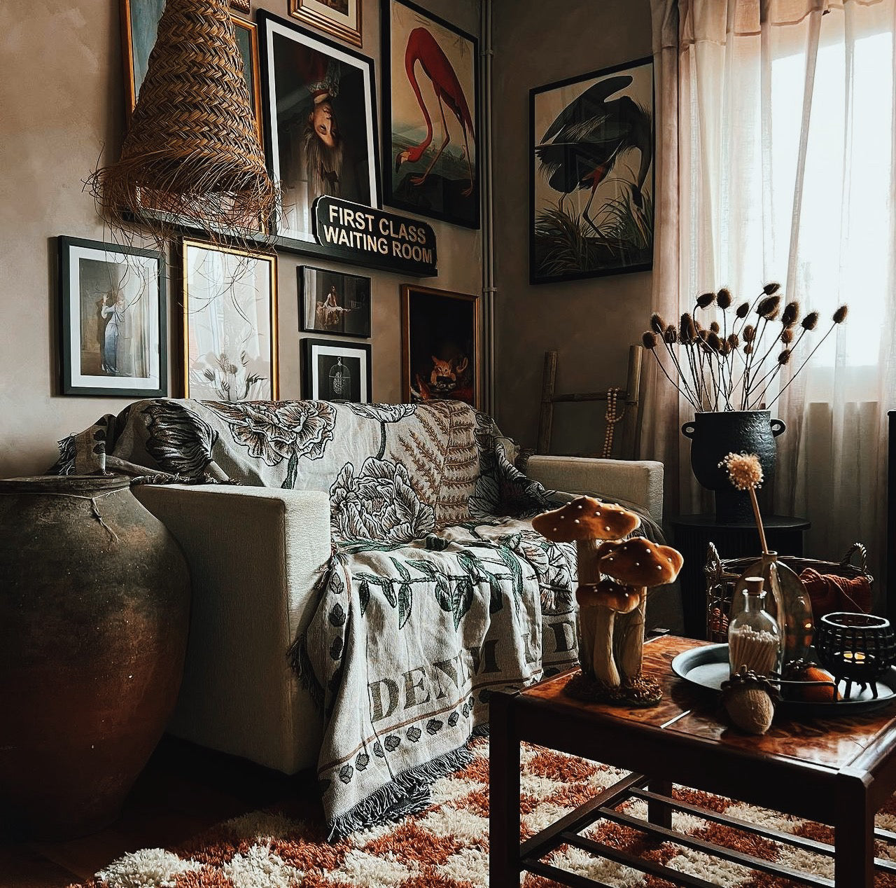 Light floral woven throw blanket styled over a sofa in a cosy living room.
