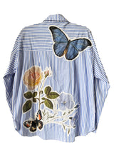 Blue and white striped shirt with floral and butterfly designs on a white background