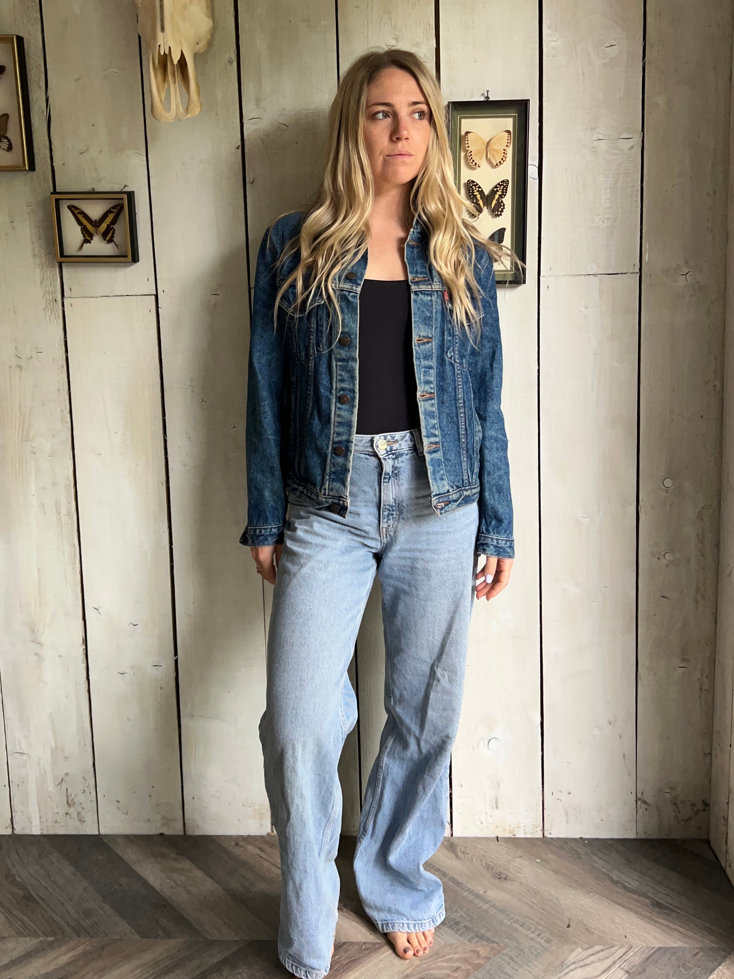 Blue denim jacket with button-front design, front view.