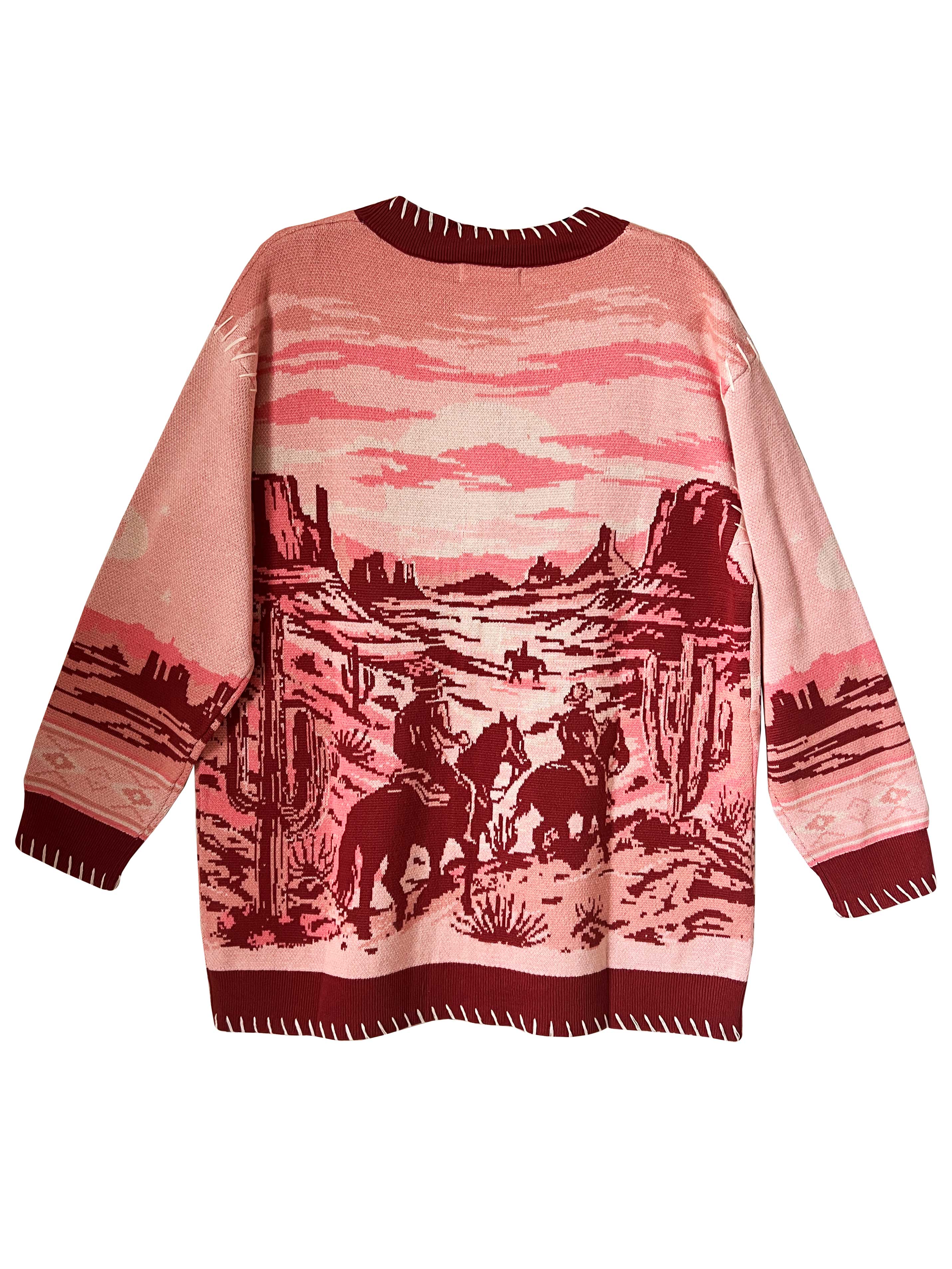 A long-sleeved jacquard knit cardigan with a desert landscape design in shades of pink and warm crimson.