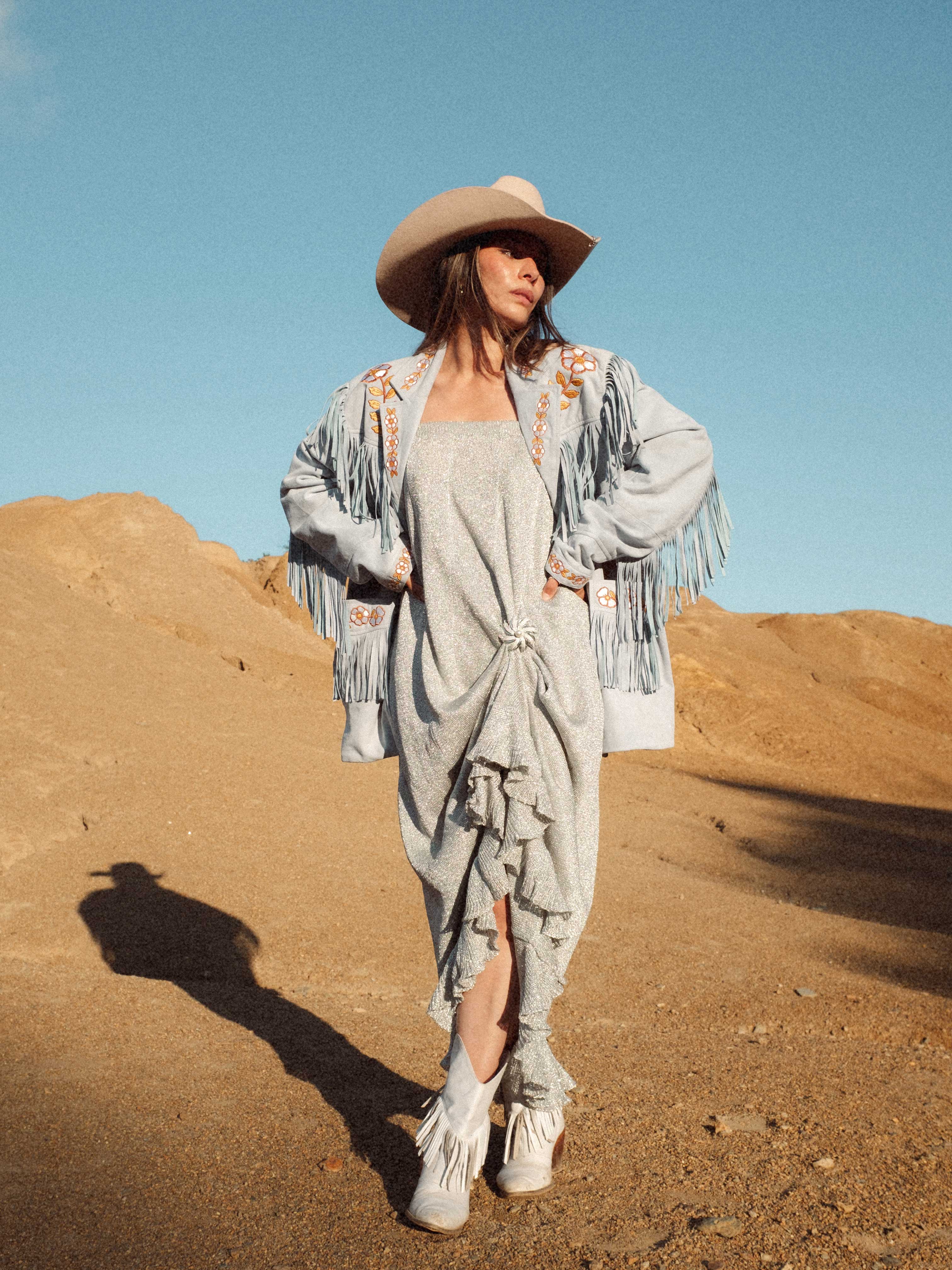 Blue suede Western fringe jacket with floral embroidery styled with cowboy hat