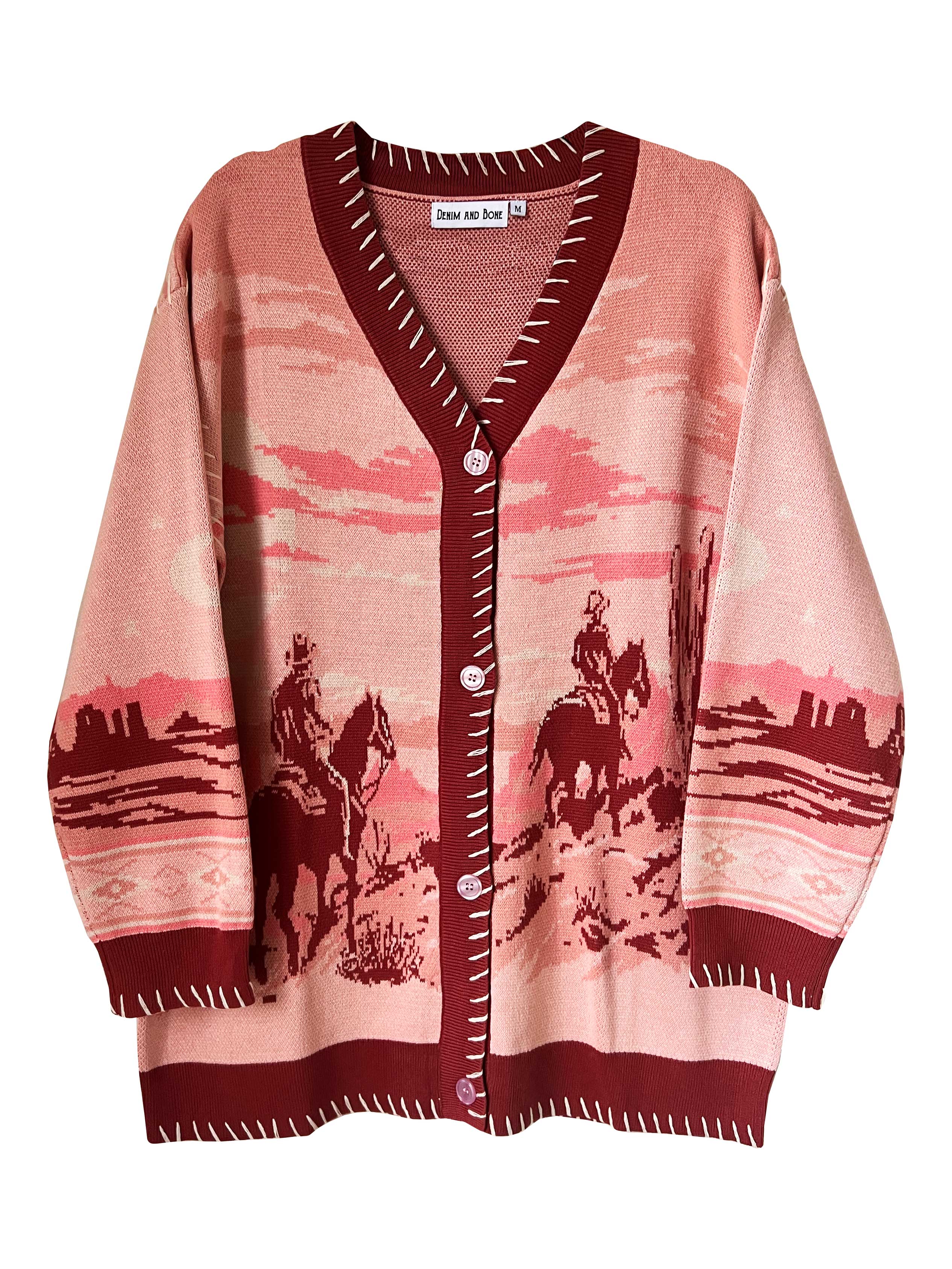 A long-sleeved jacquard knit cardigan with a desert landscape design in shades of pink and warm crimson, featuring a classic V-neckline and button-front closure.