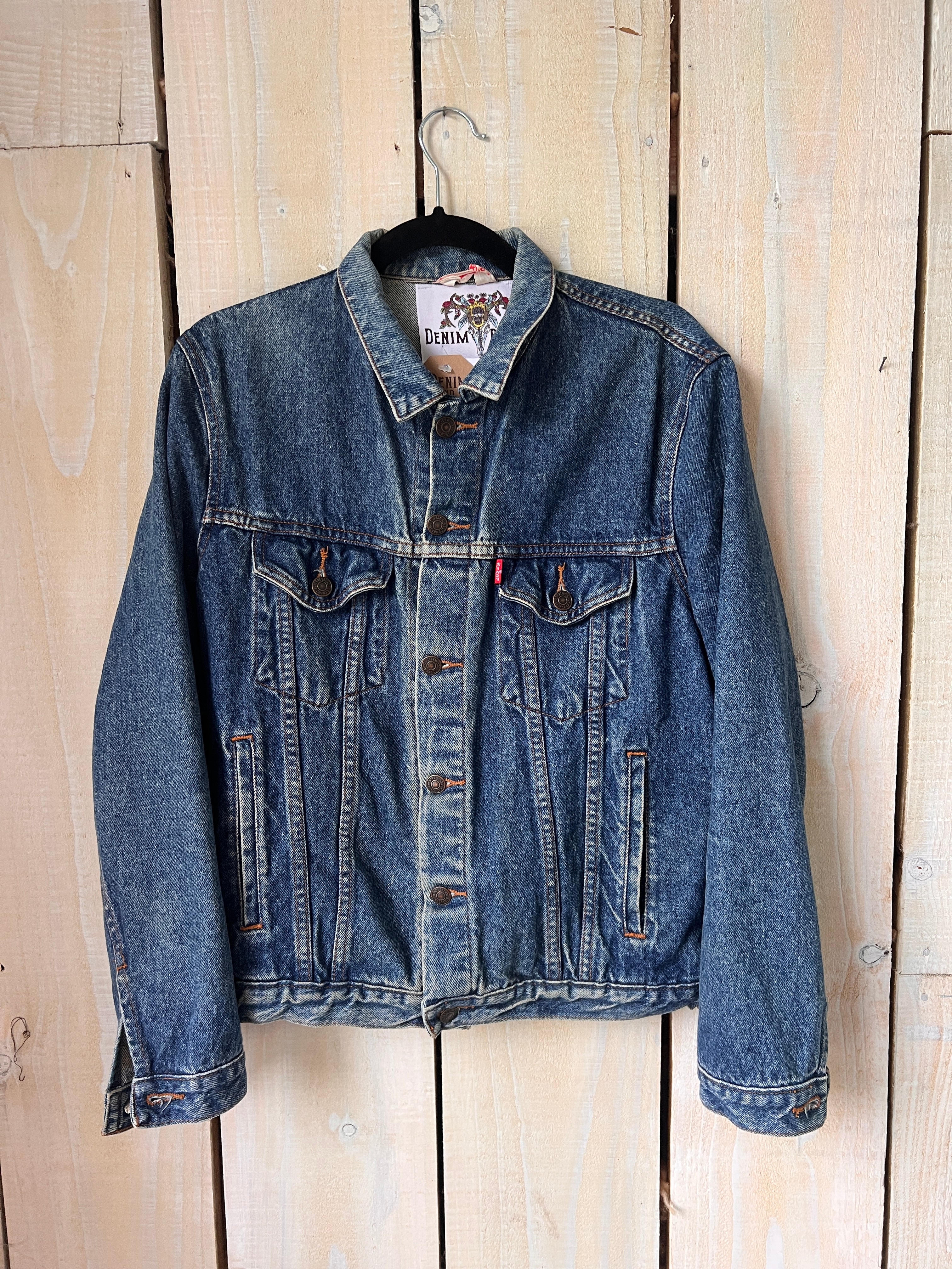 Blue denim jacket with button-front design, front view.