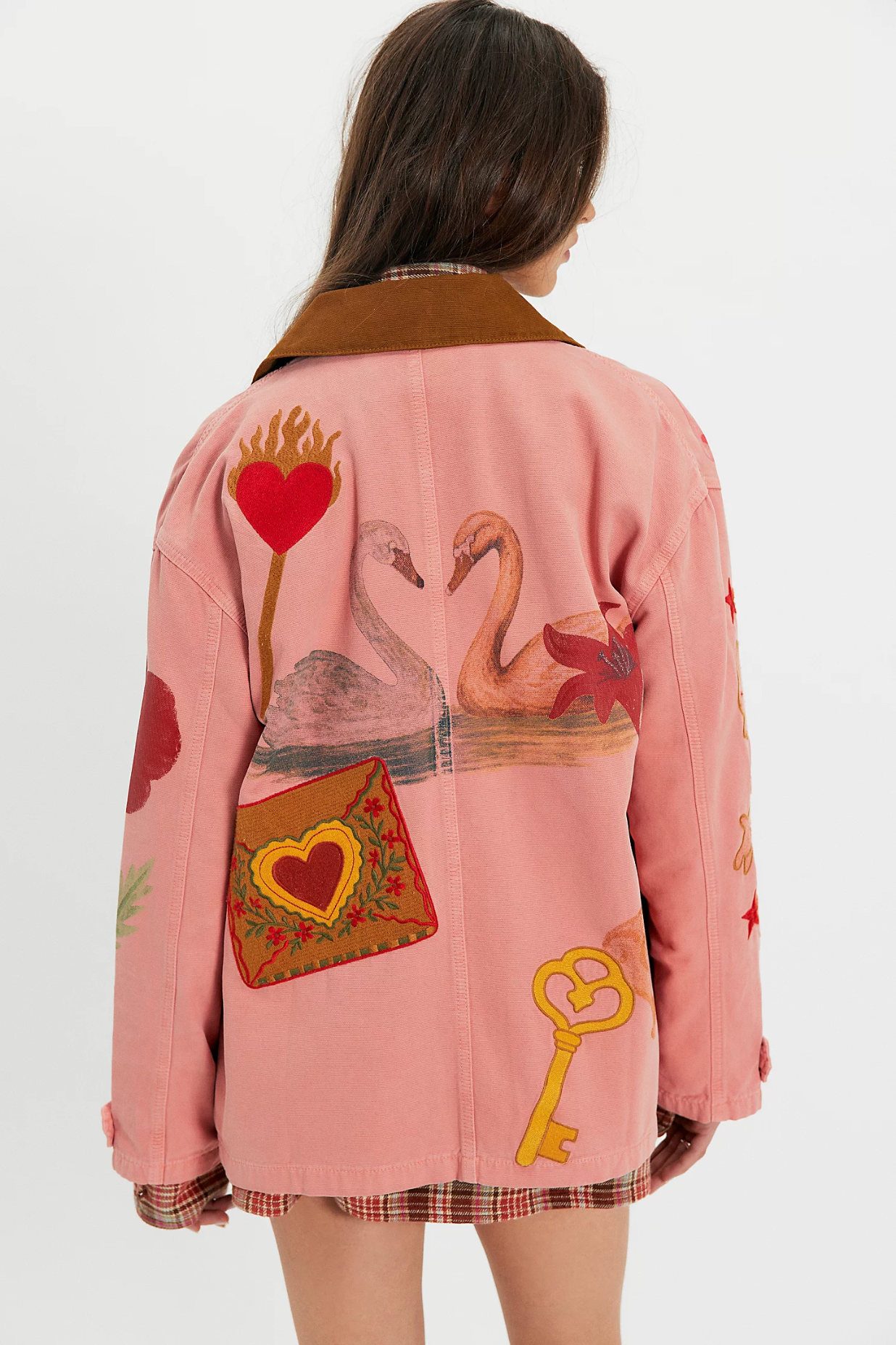 Woman wearing a pink hand-painted jacket featuring cherry, flower, heart, and bunny artwork back view