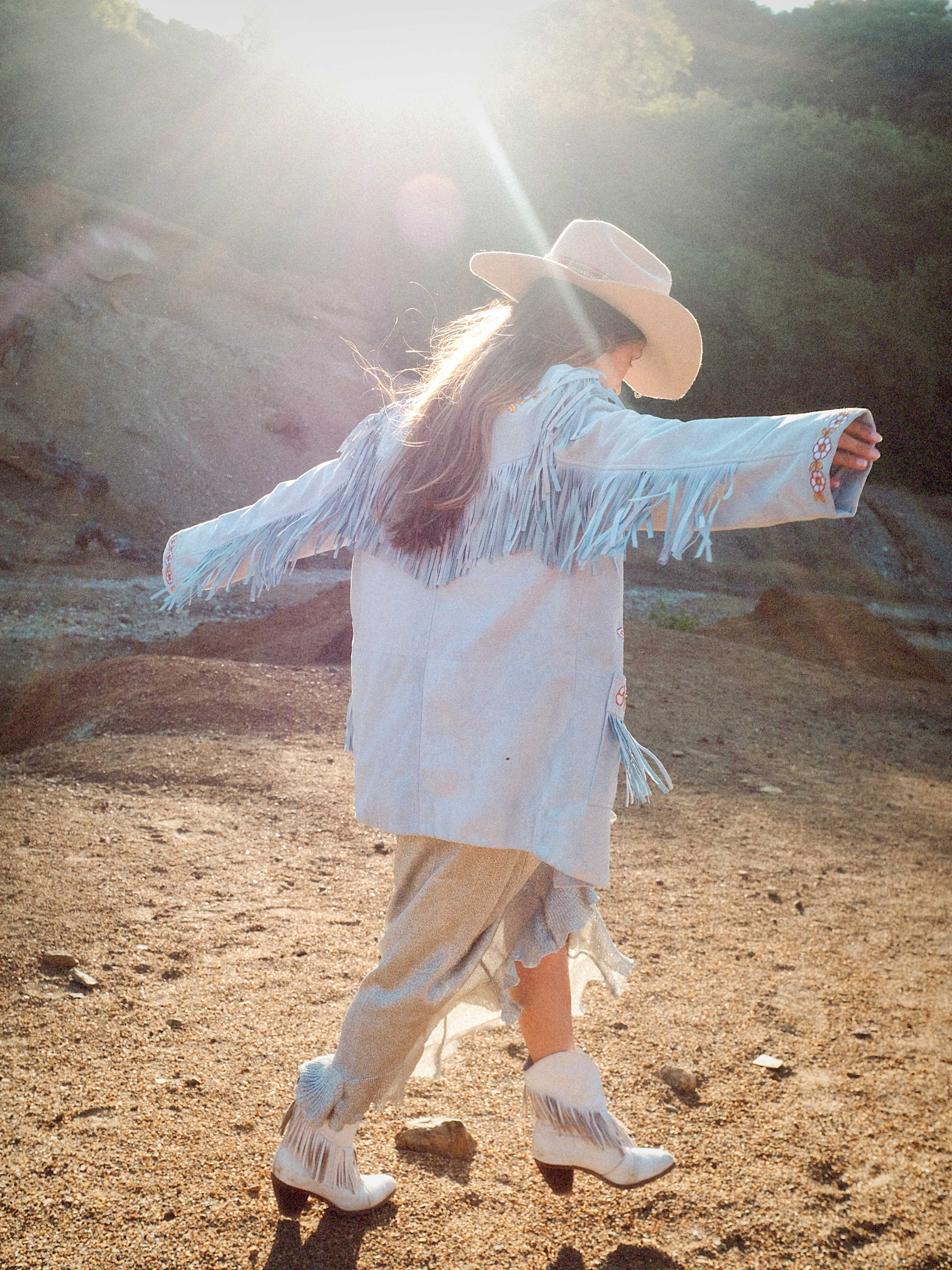 Canyon Bloom embroidered suede jacket with long fringe detailing across the back and sleeves