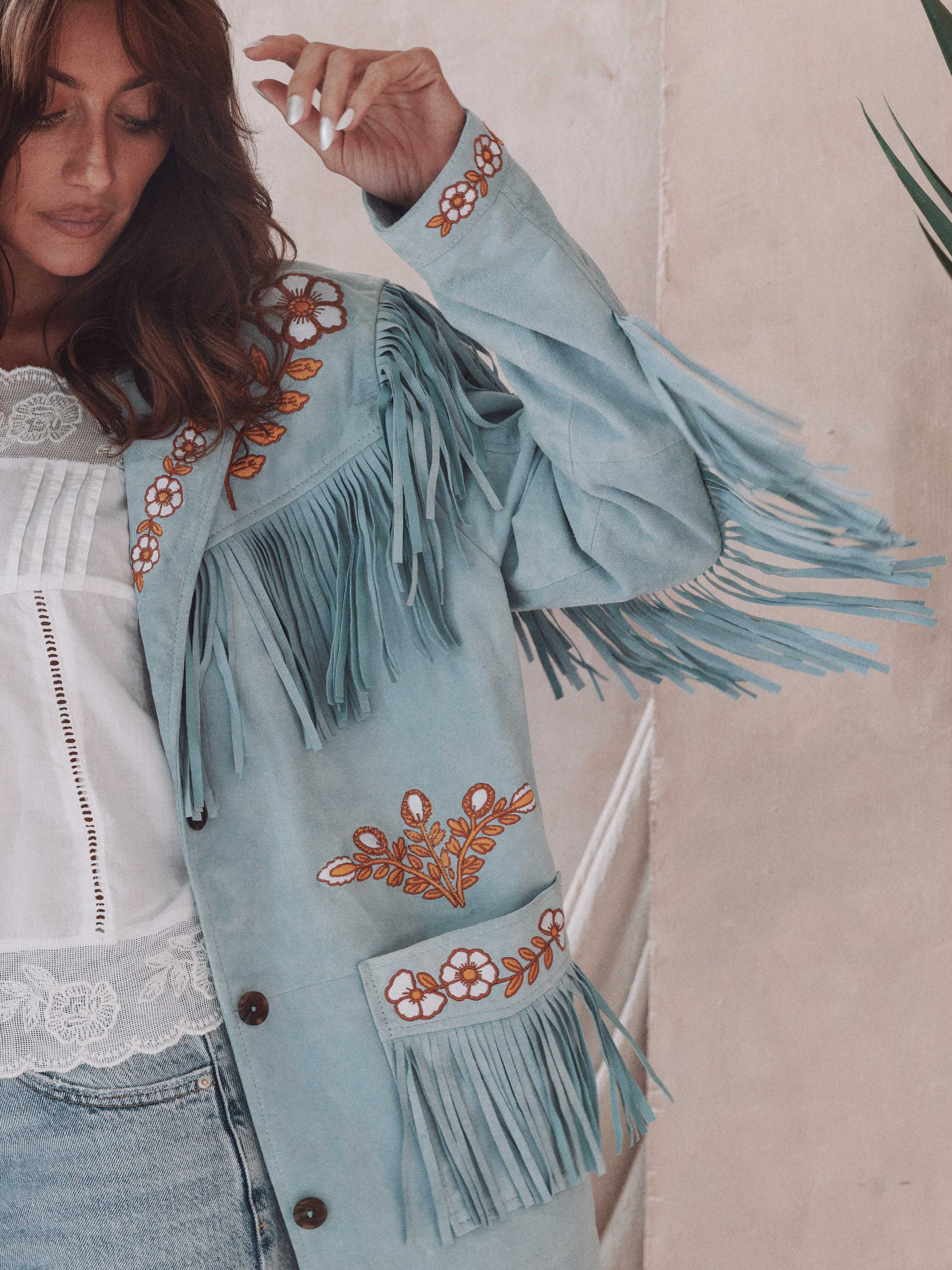 Powder blue suede fringe jacket with orange and white floral embroidery