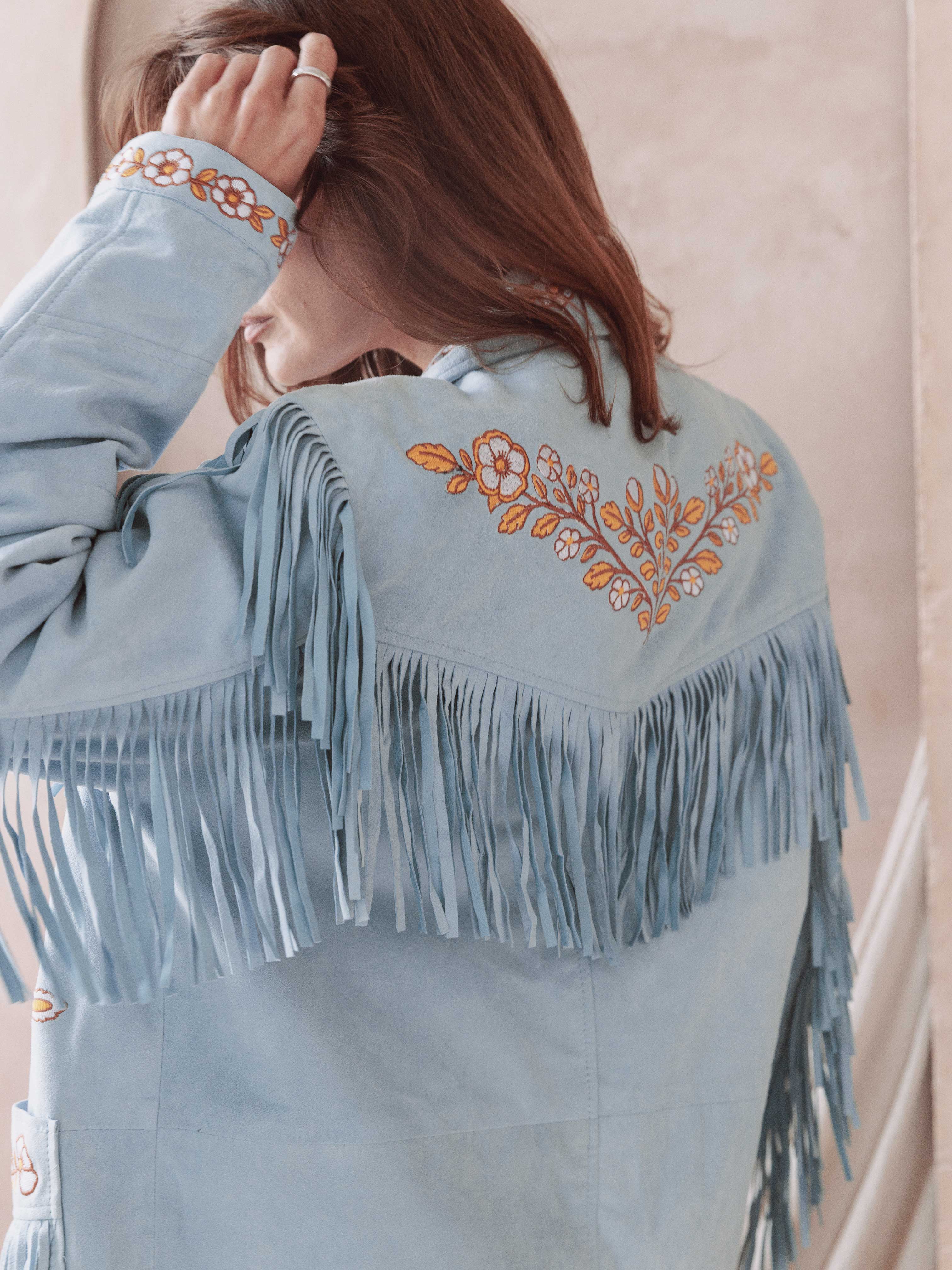Blue suede Western jacket with embroidered floral back detail and statement fringe