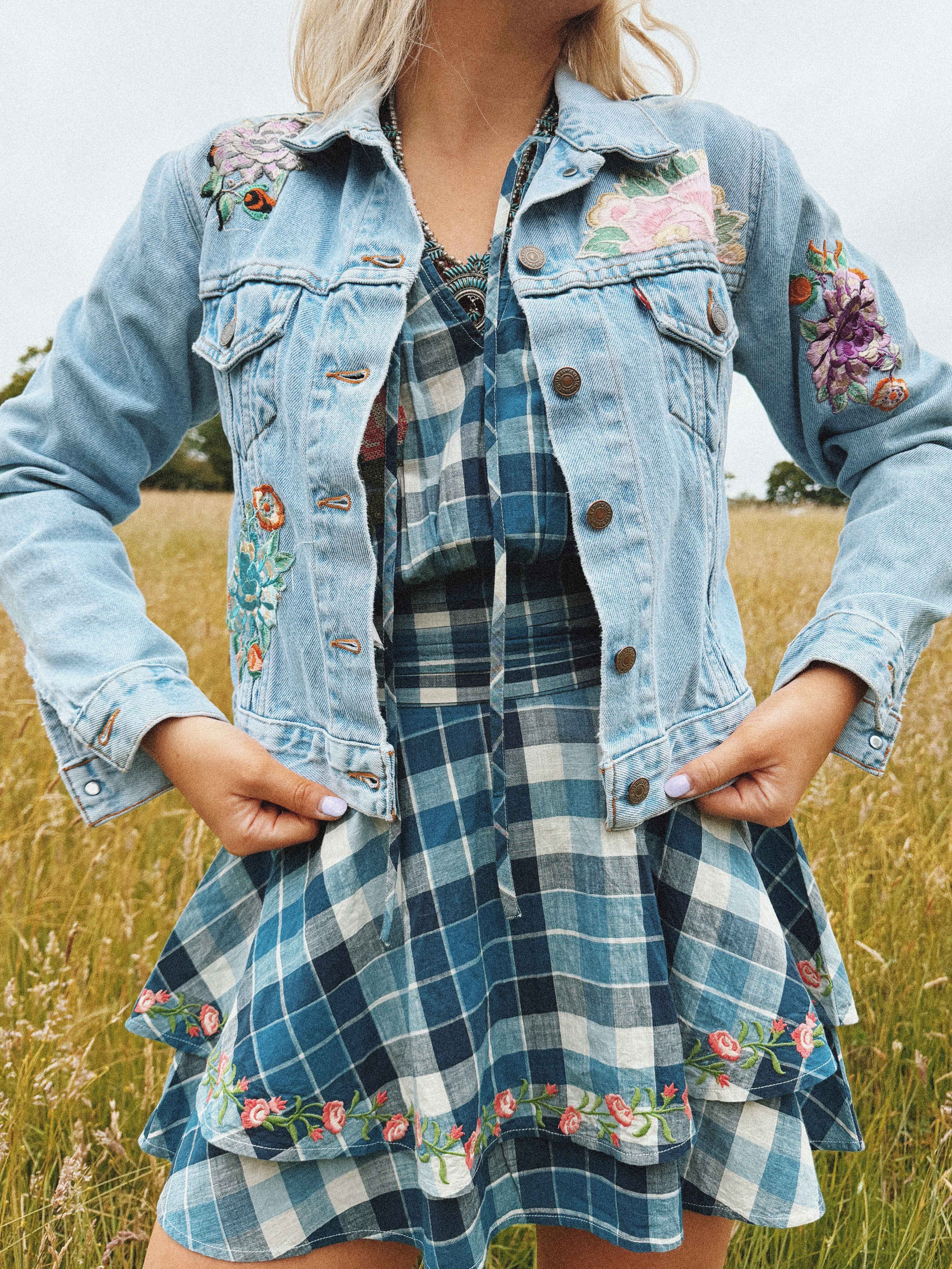 Light blue denim jacket with colourful vintage textile patchwork on the front, shown from the front