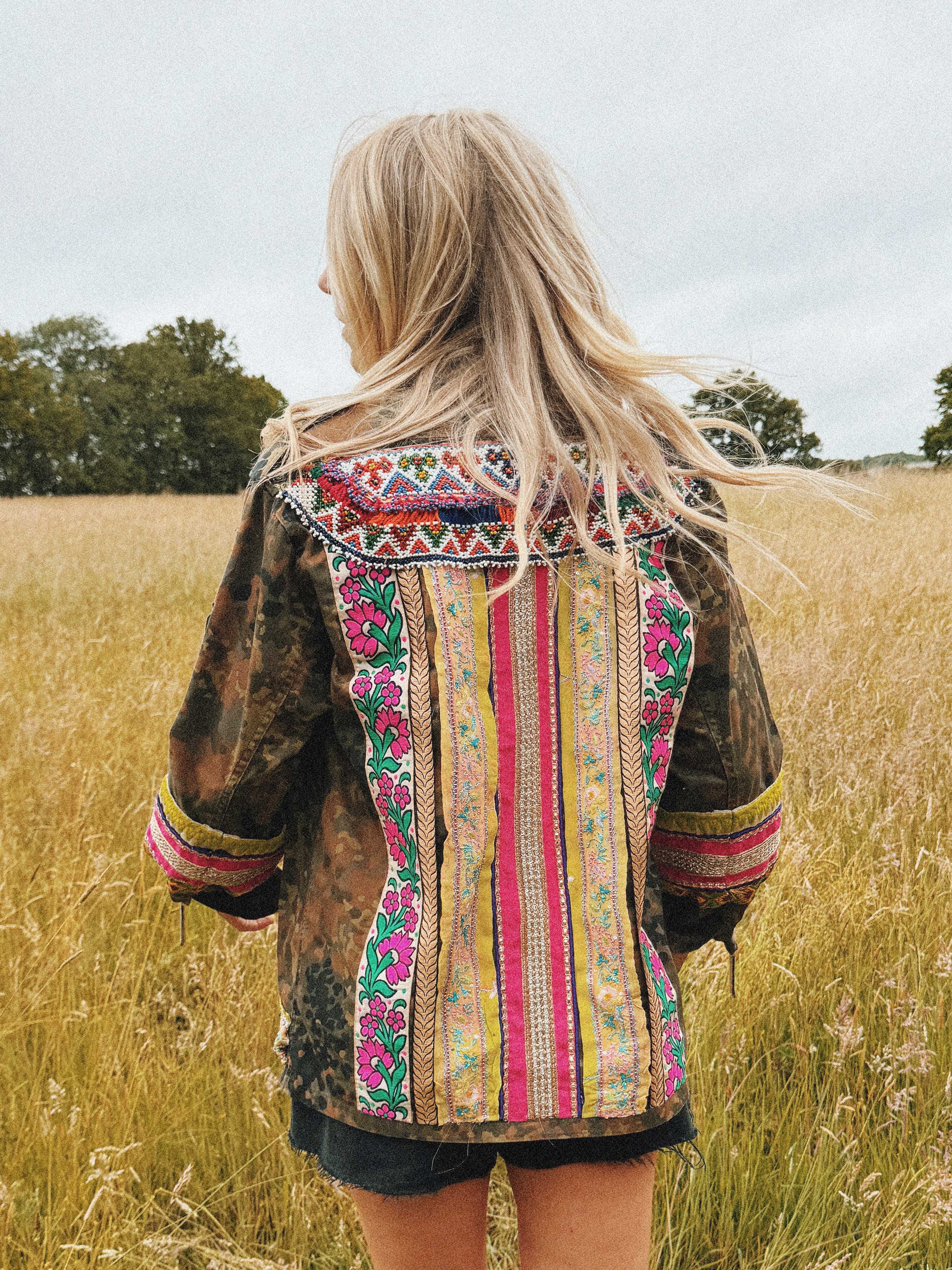 Embellished camouflage jacket with beaded trim, embroidered back panel, and decorative, shown from the back.