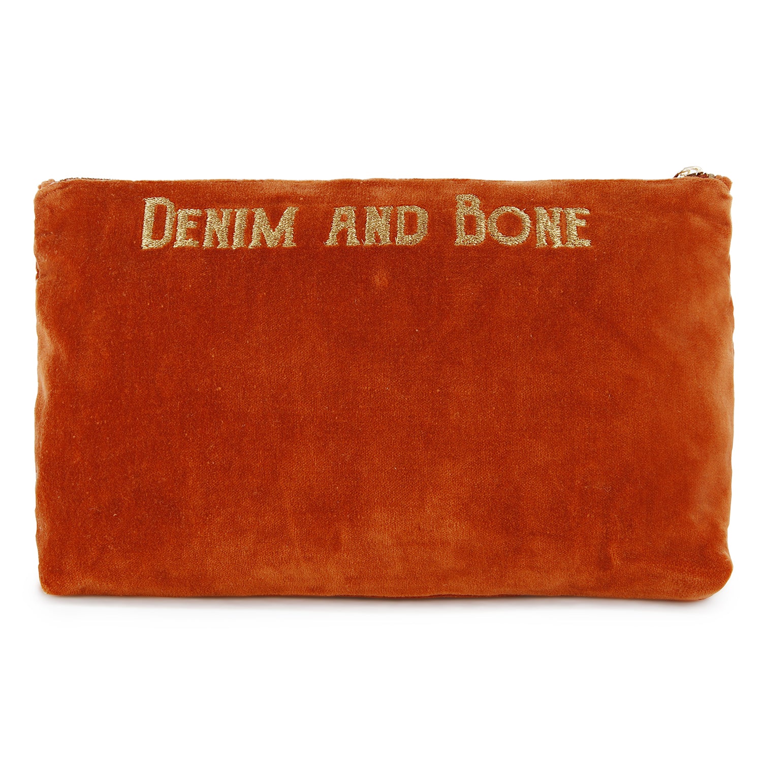 Back of rich rust velvet zip pouch embroidered with the Denim and Bone logo.