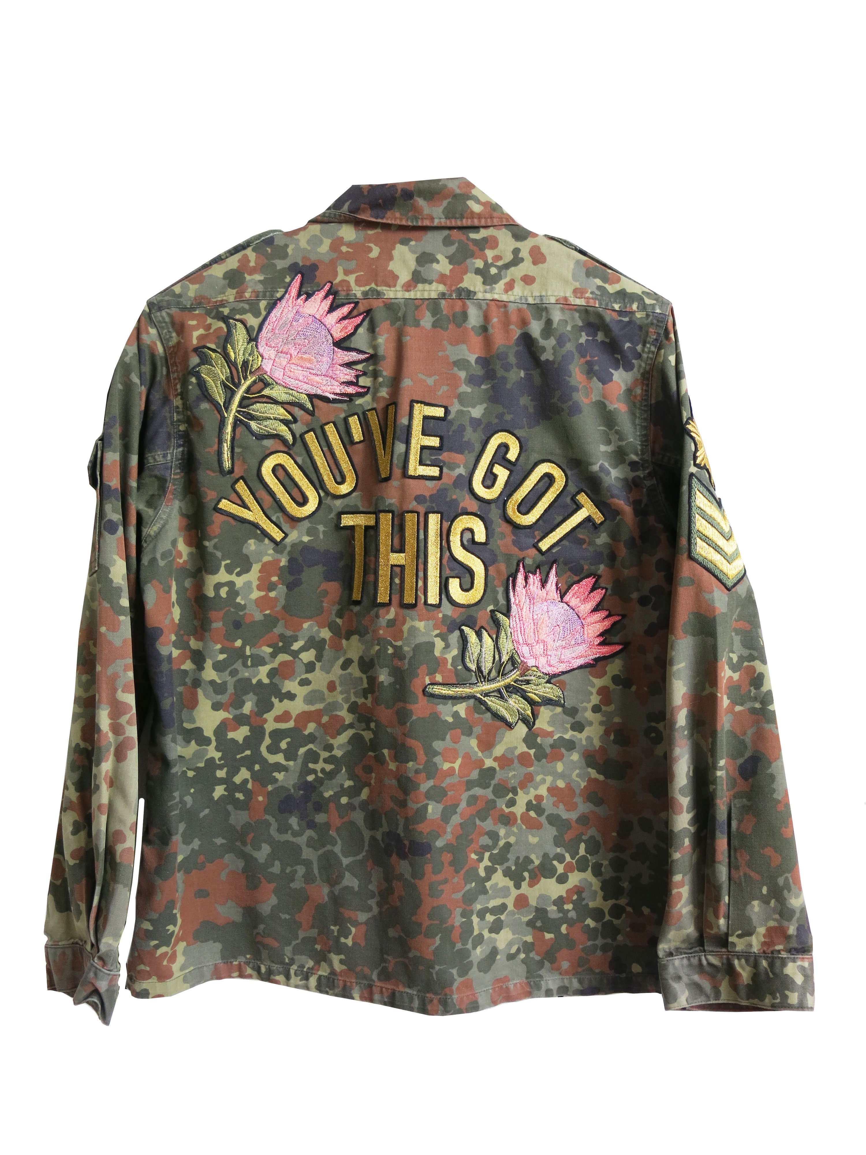 Camouflage military jacket with floral embroidered back design and "YOU'VE GOT THIS" lettering, shown from the back.