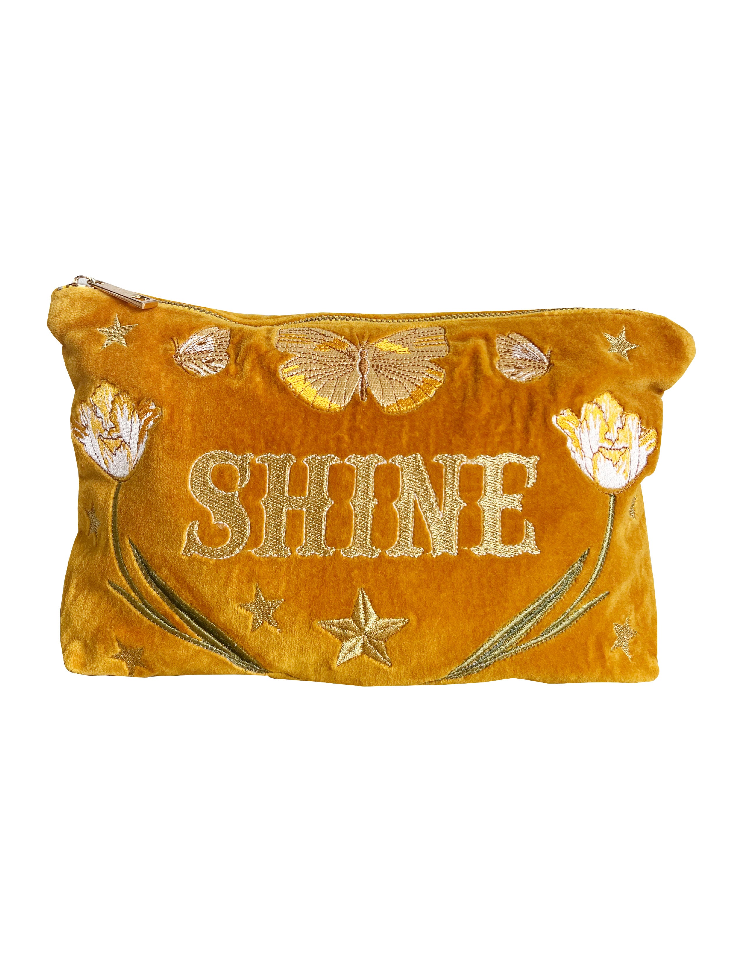 Golden yellow velvet zip pouch embroidered with the word "SHINE," butterflies, tulips, and stars on a white background.
